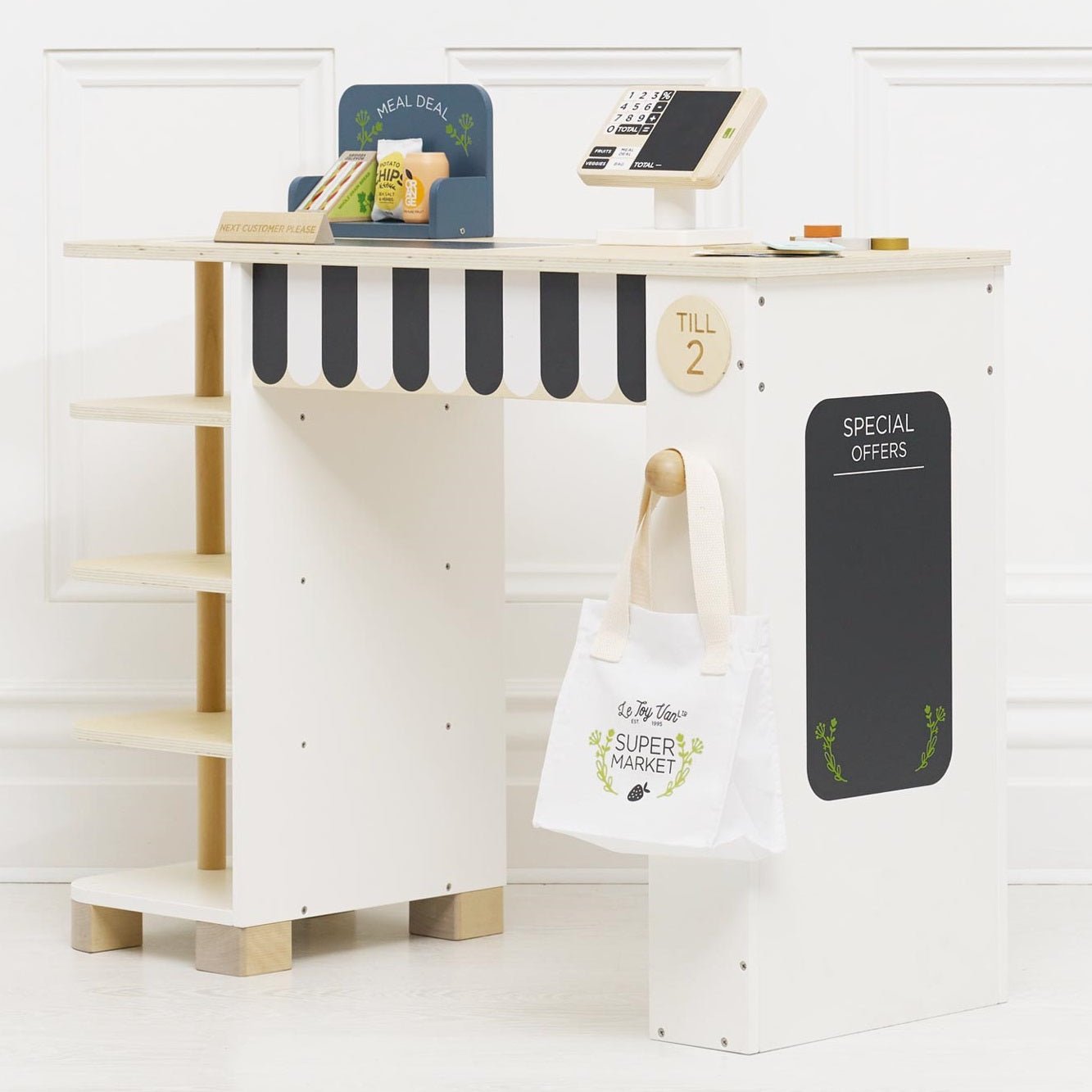 Children's play kitchen set with shelves, signboards, and a tote bag on a white background