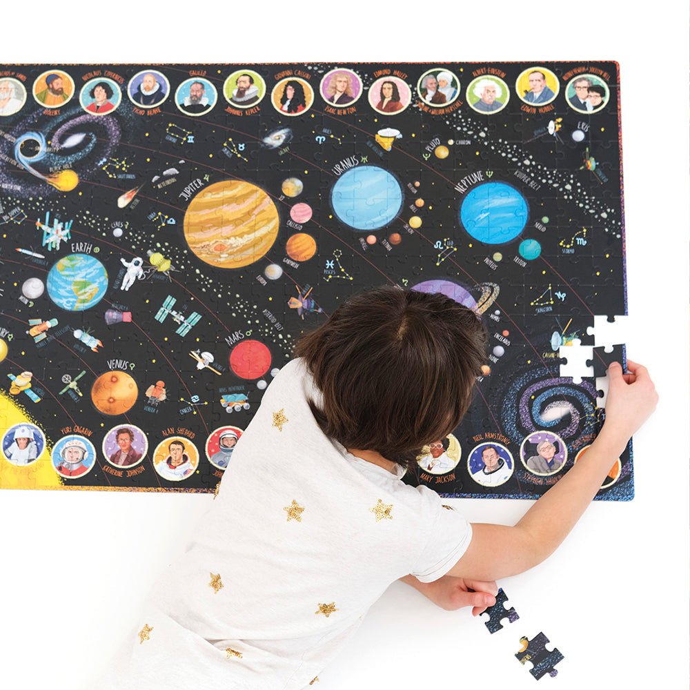 Child playing with a solar system-themed puzzle