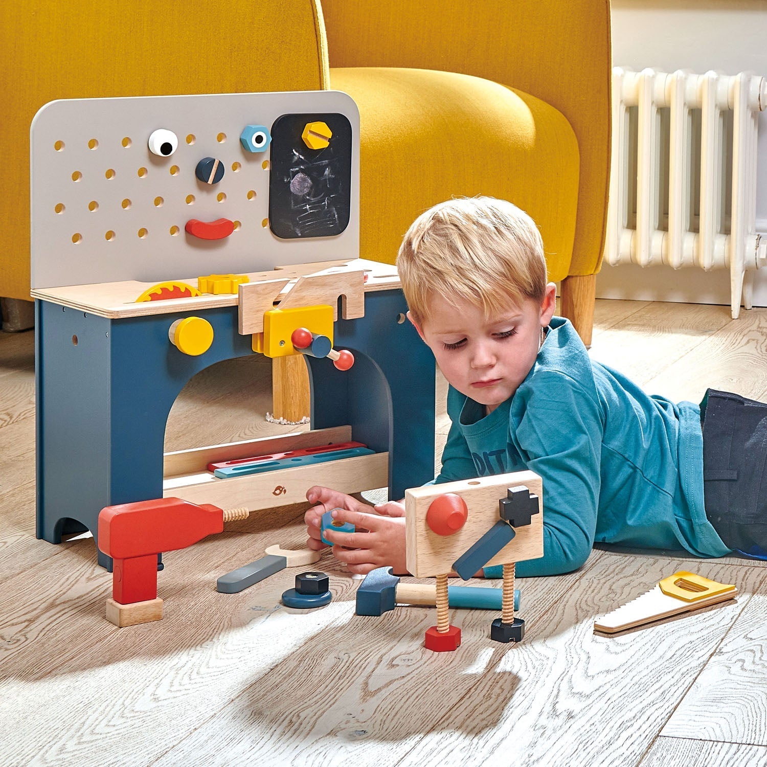 Child playing with a wooden toy set on the floor