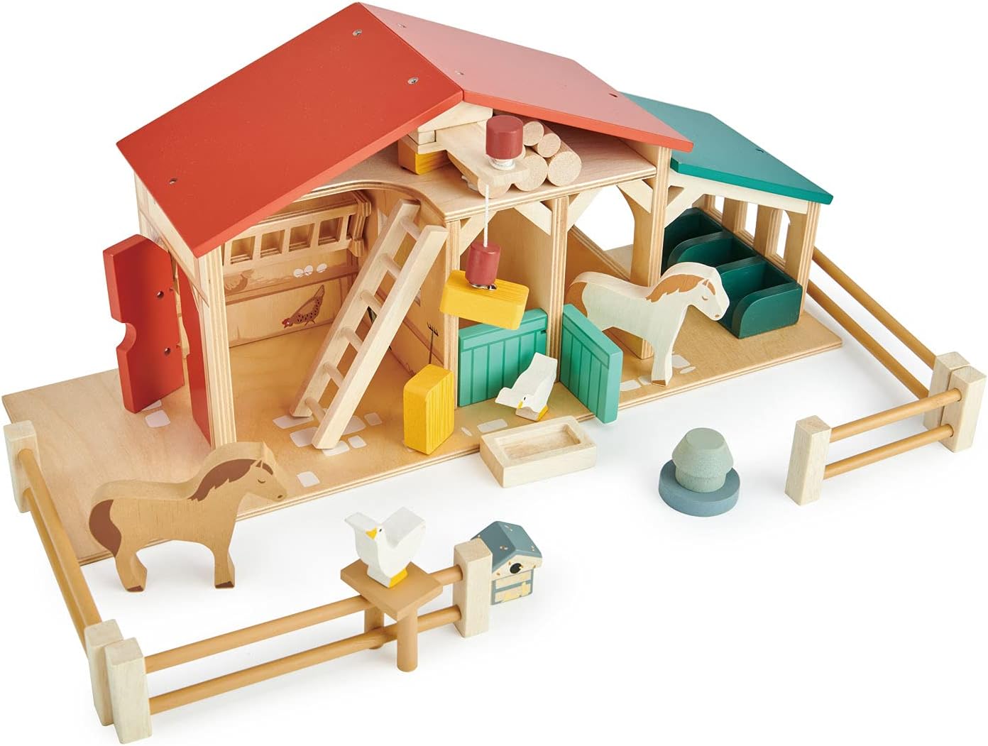 Wooden toy stable with horses and accessories on a white background