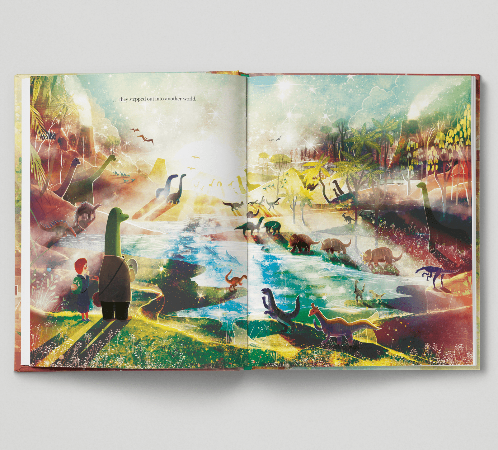 Open book with colorful illustrations of a child and dinosaur-like creatures in a fantasy landscape.
