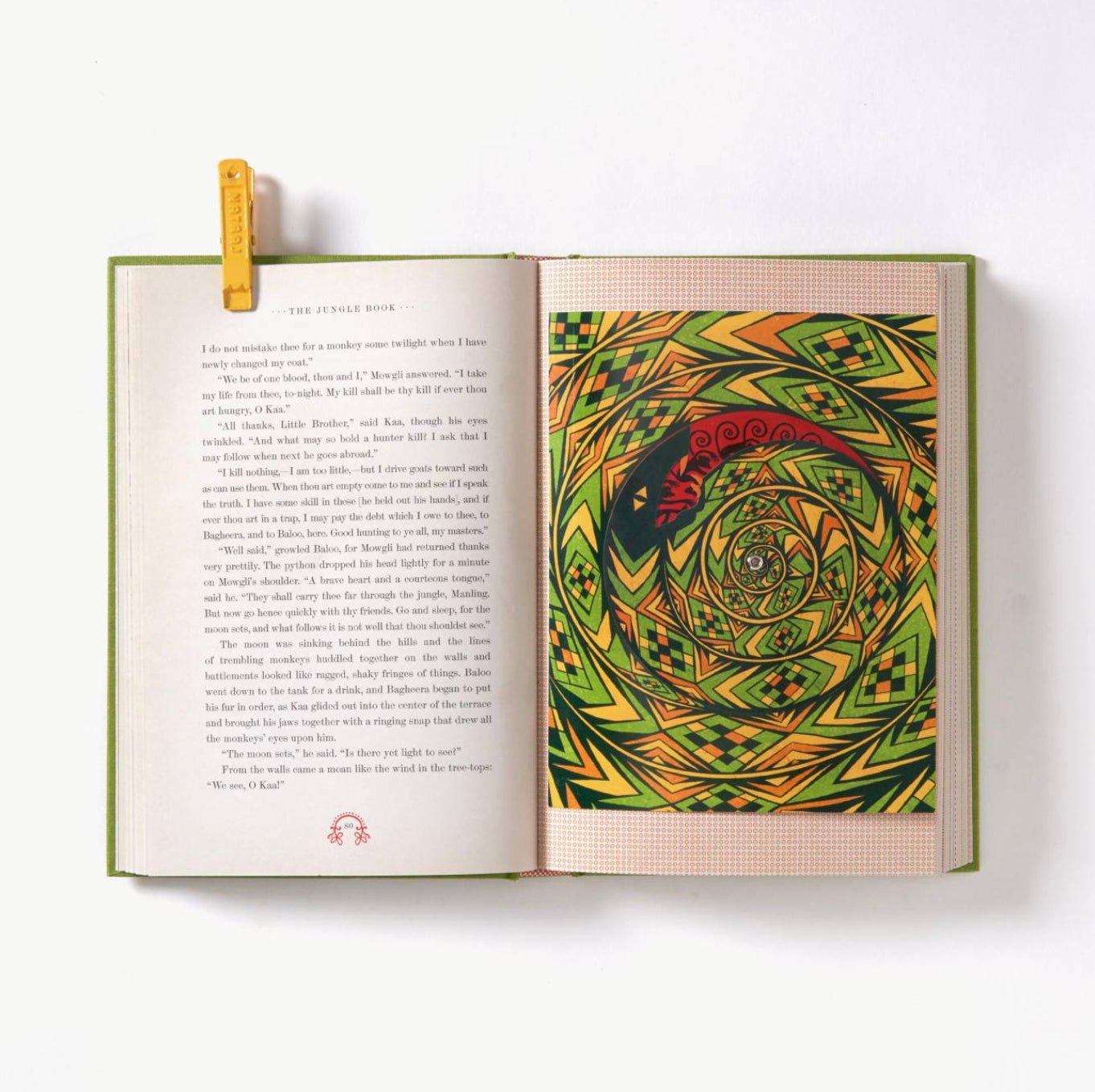 Open book with a colorful geometric design on a white background