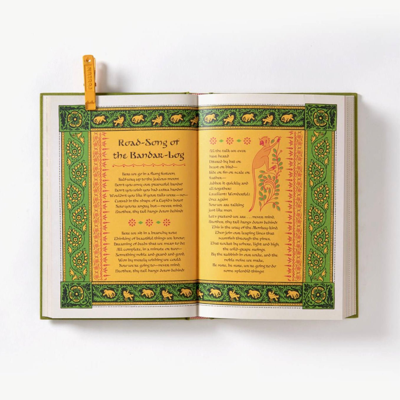 Open book with decorative text and illustrations on a white background
