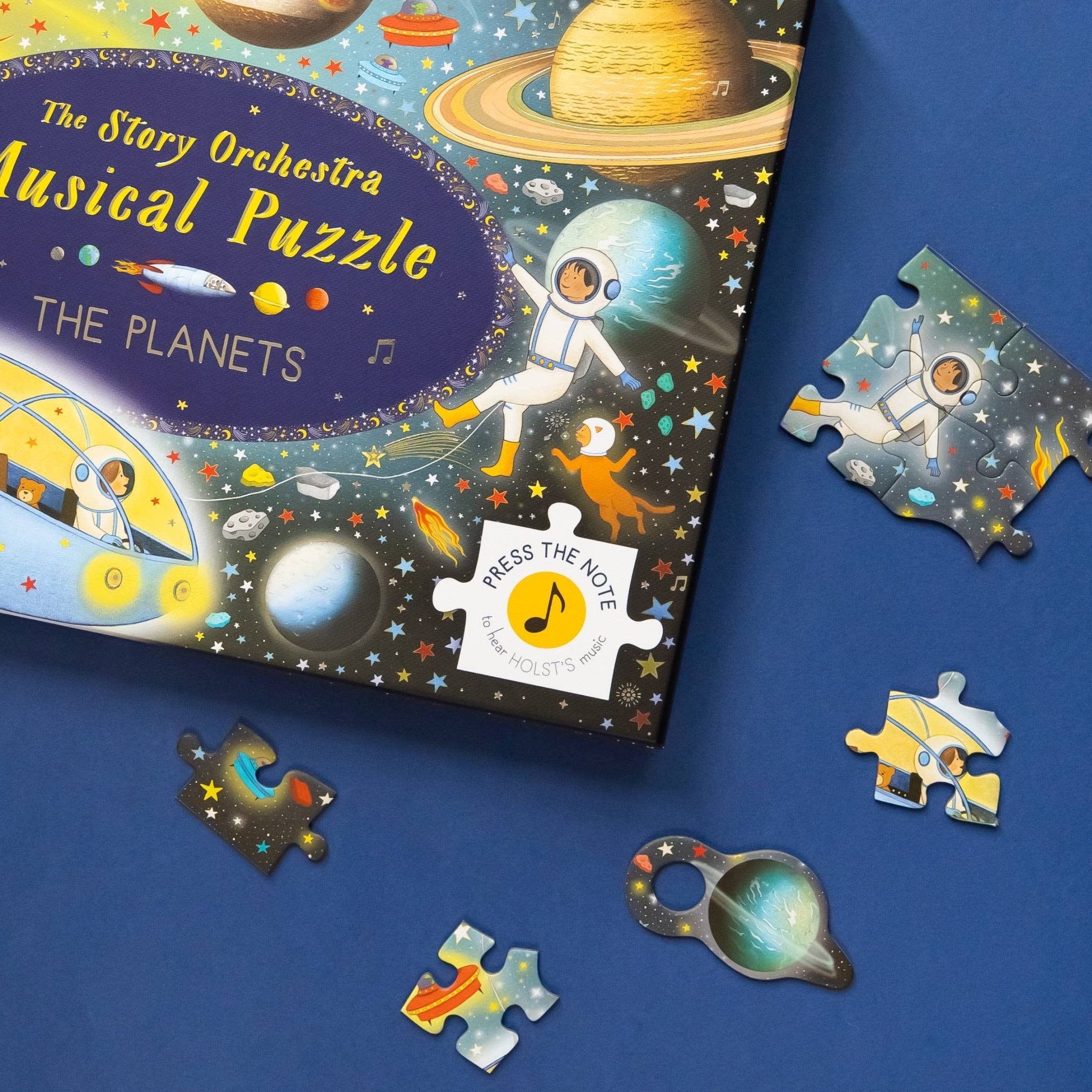 Children's puzzle set with space-themed design and pieces on a blue background