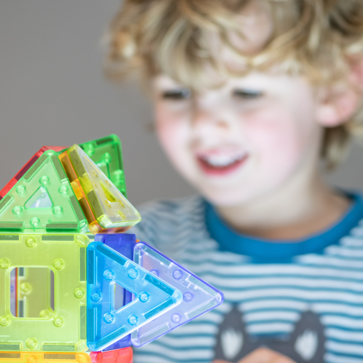 Child playing with colorful magnetic building blocks