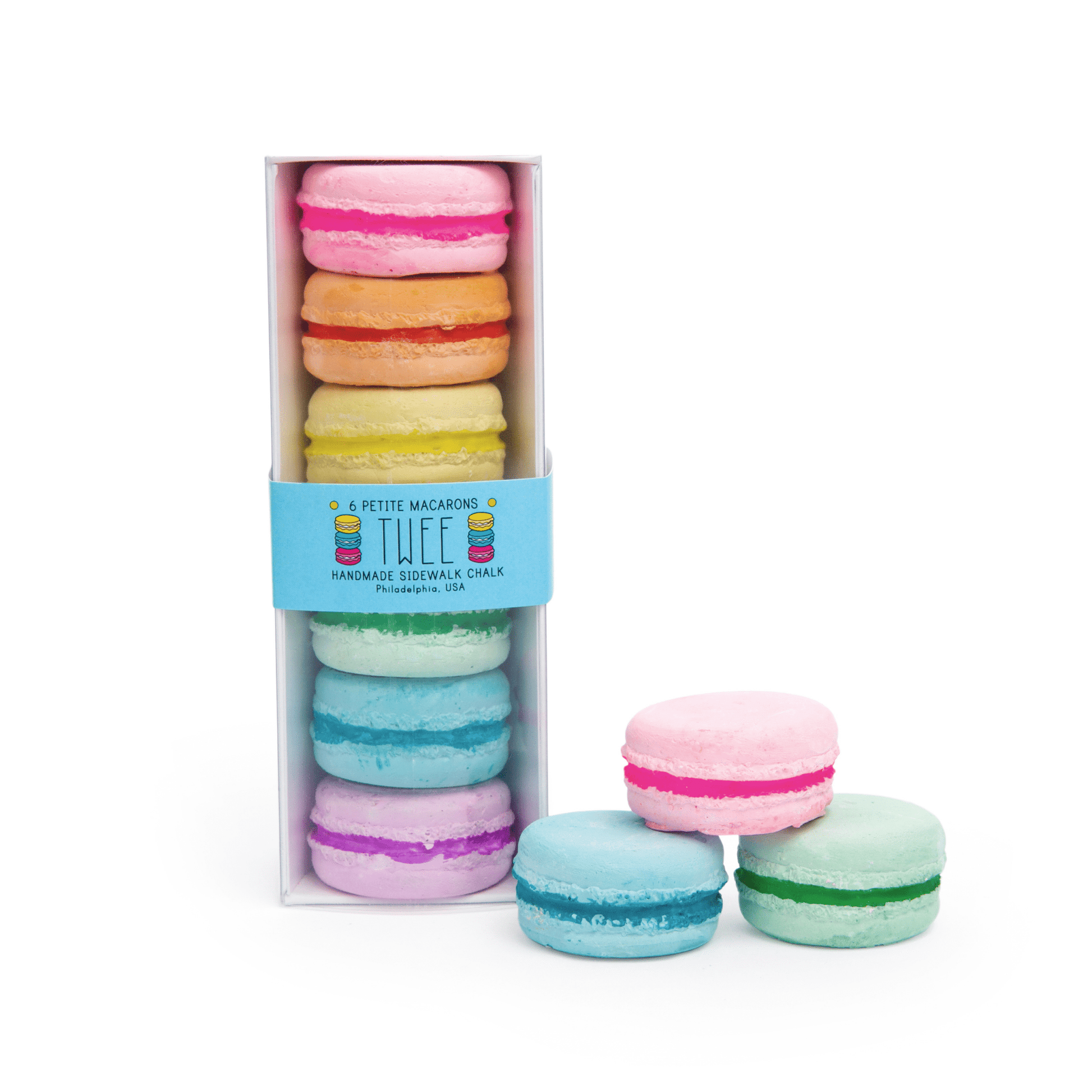 Pastel-colored macaron cookies in a box with 'THEE' branding on a white background