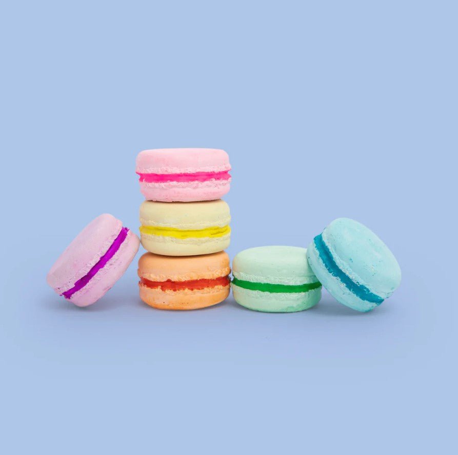 Colorful macaron cookies on a light blue background