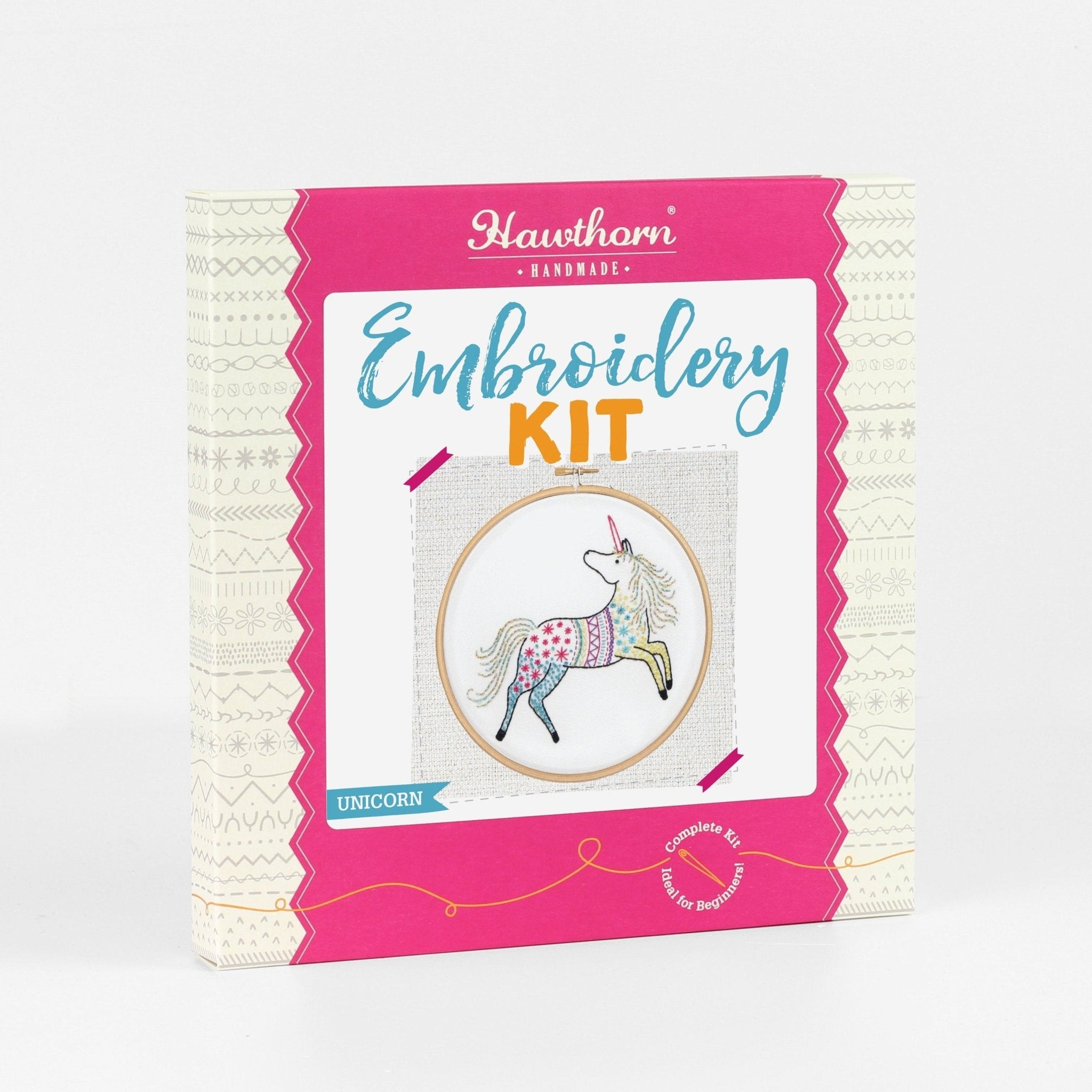 Embroidery kit packaging with unicorn design on a white background