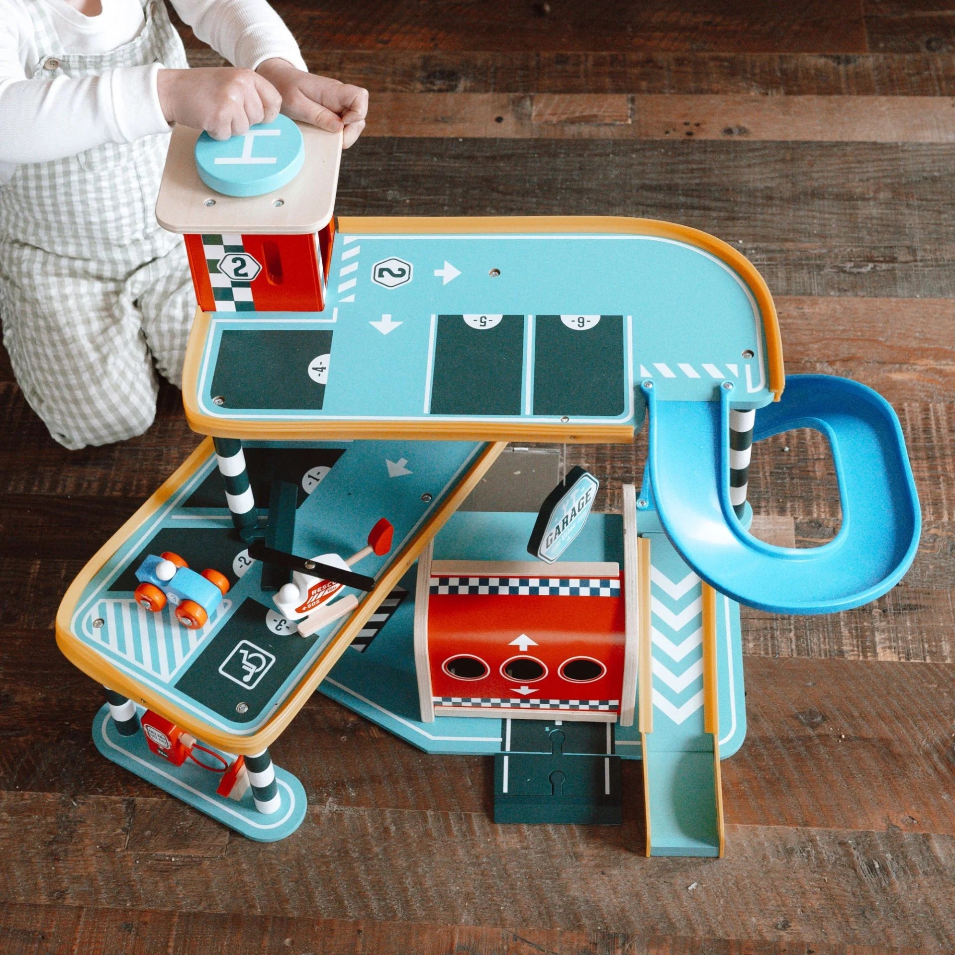 Children's toy race track set on a wooden floor