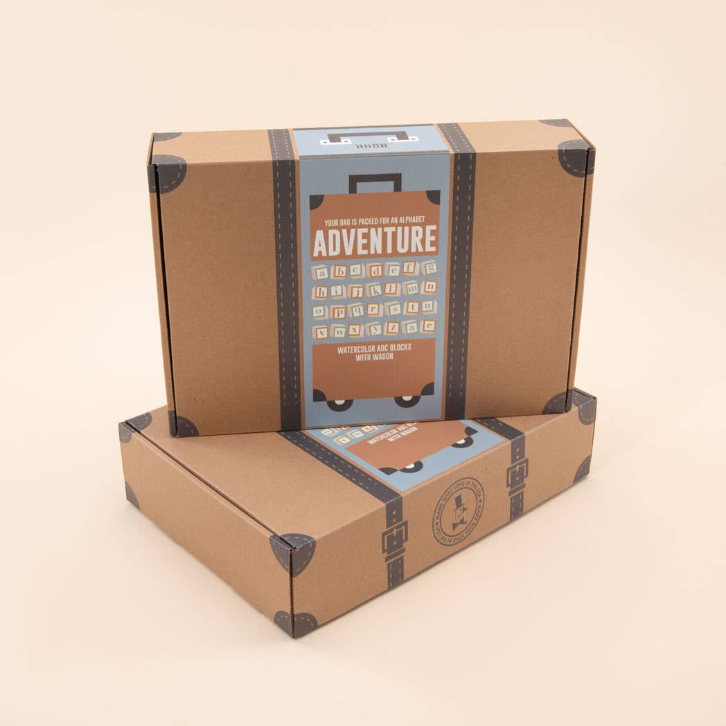 Cardboard box with travel-themed design and 'Adventure' text on a beige background