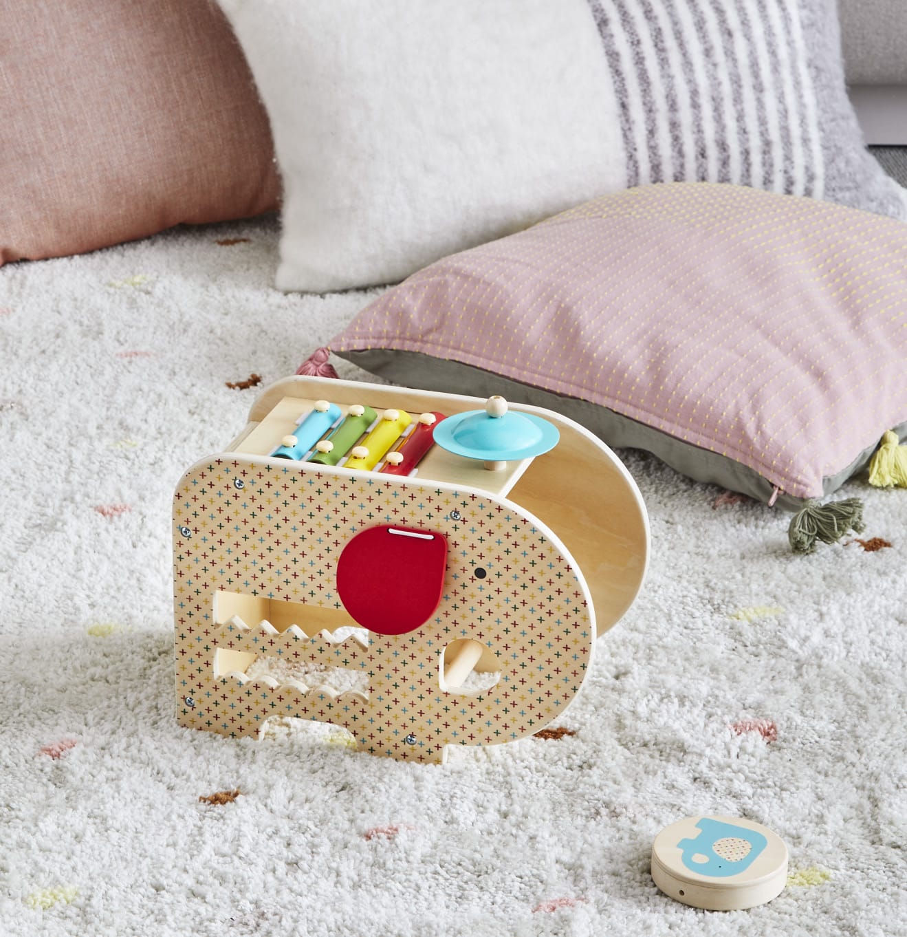 Children's toy elephant with colorful compartments on a soft surface