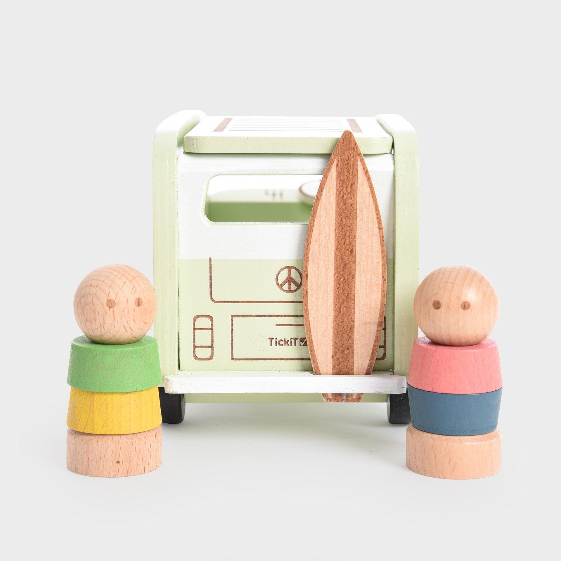 Wooden toy set with colorful blocks and a small vehicle on a light gray background