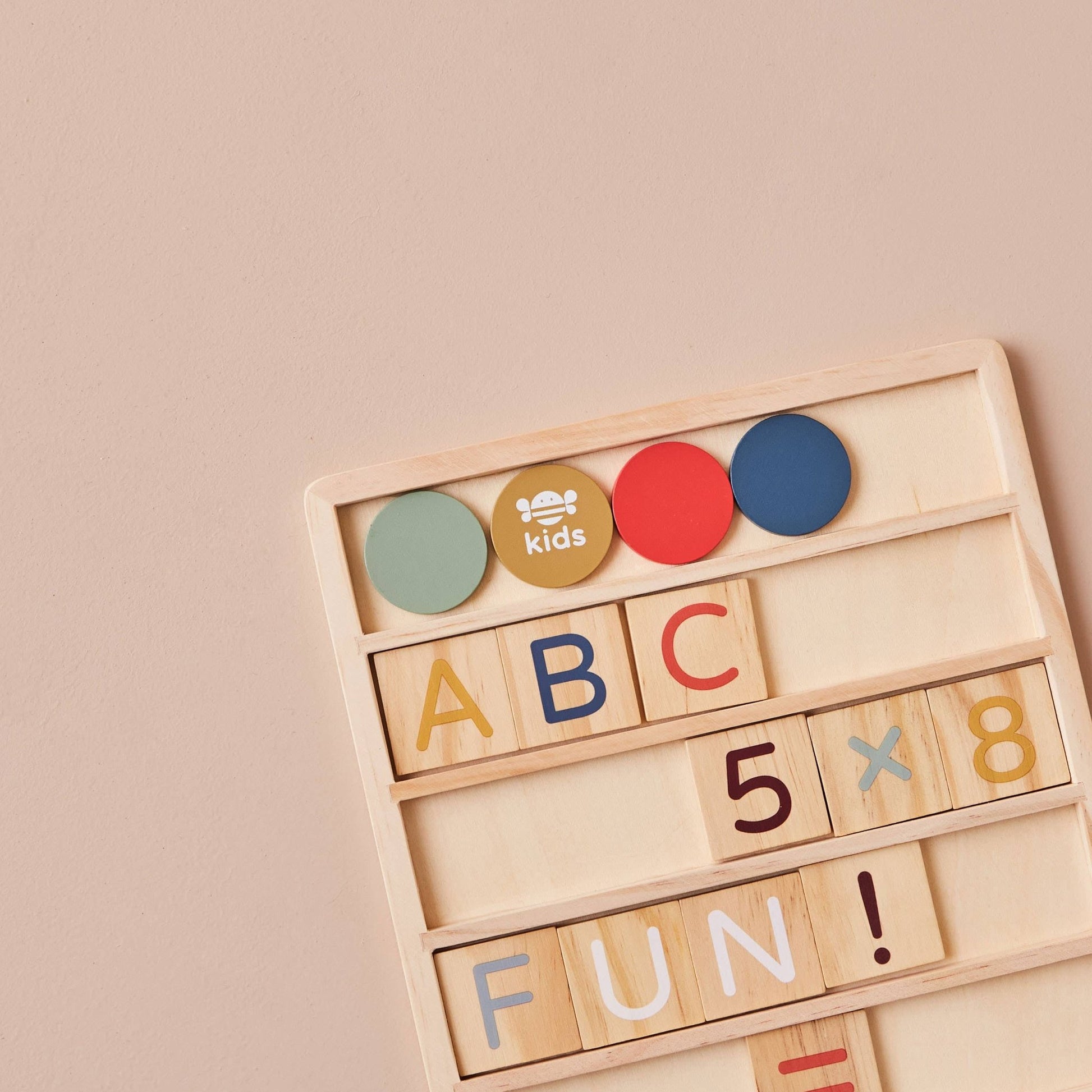 Wooden toy with colorful letters and numbers on a beige background