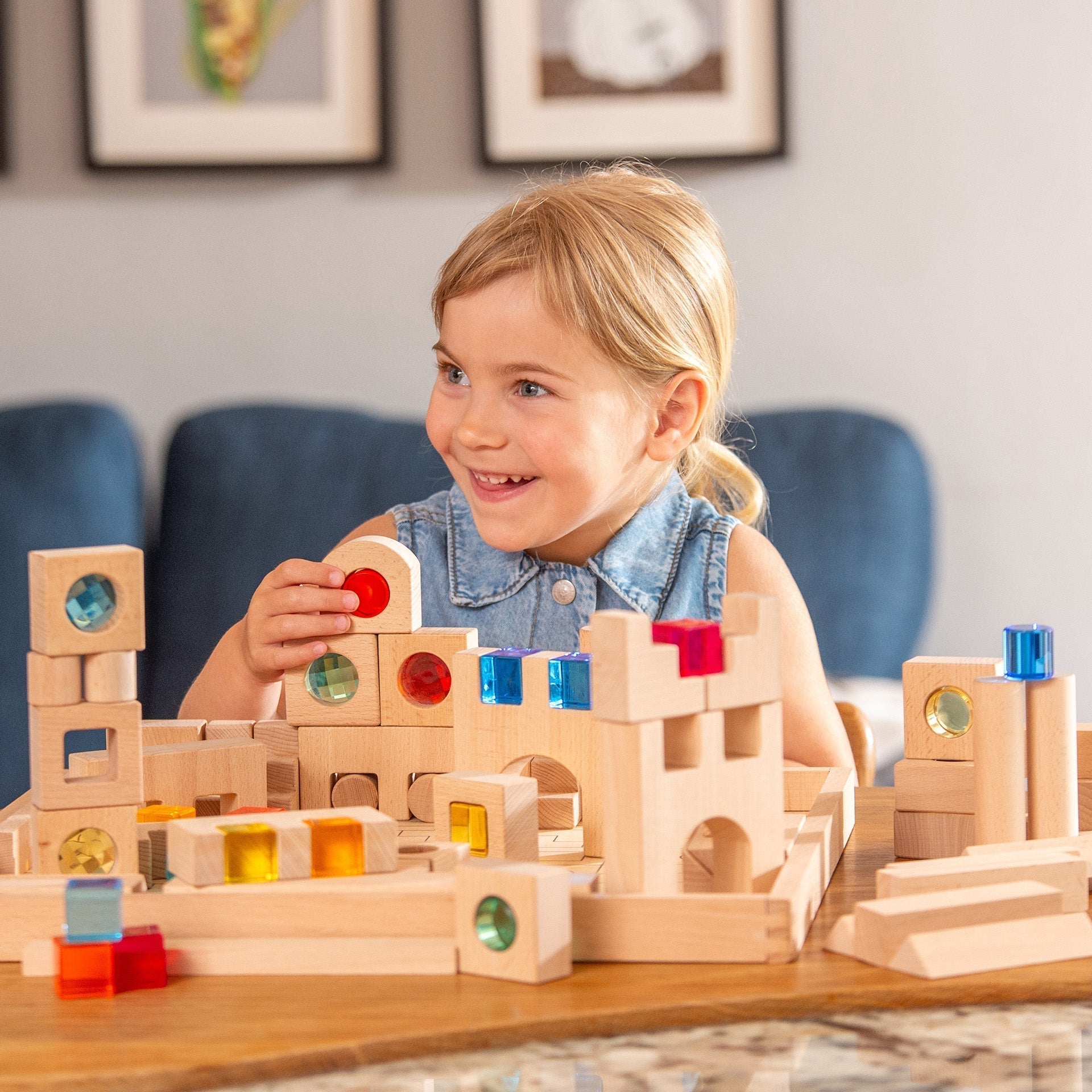 Child playing with wooden building blocks on a table