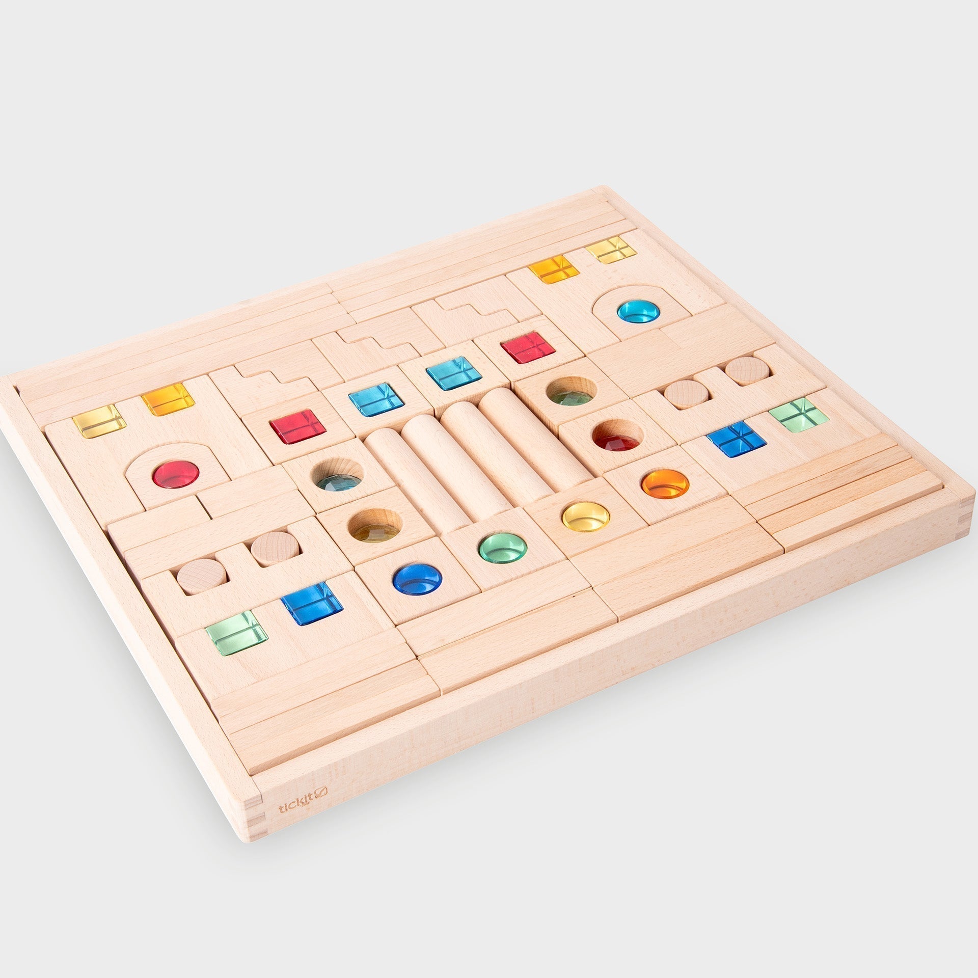 Wooden puzzle with colorful geometric shapes on a light gray background