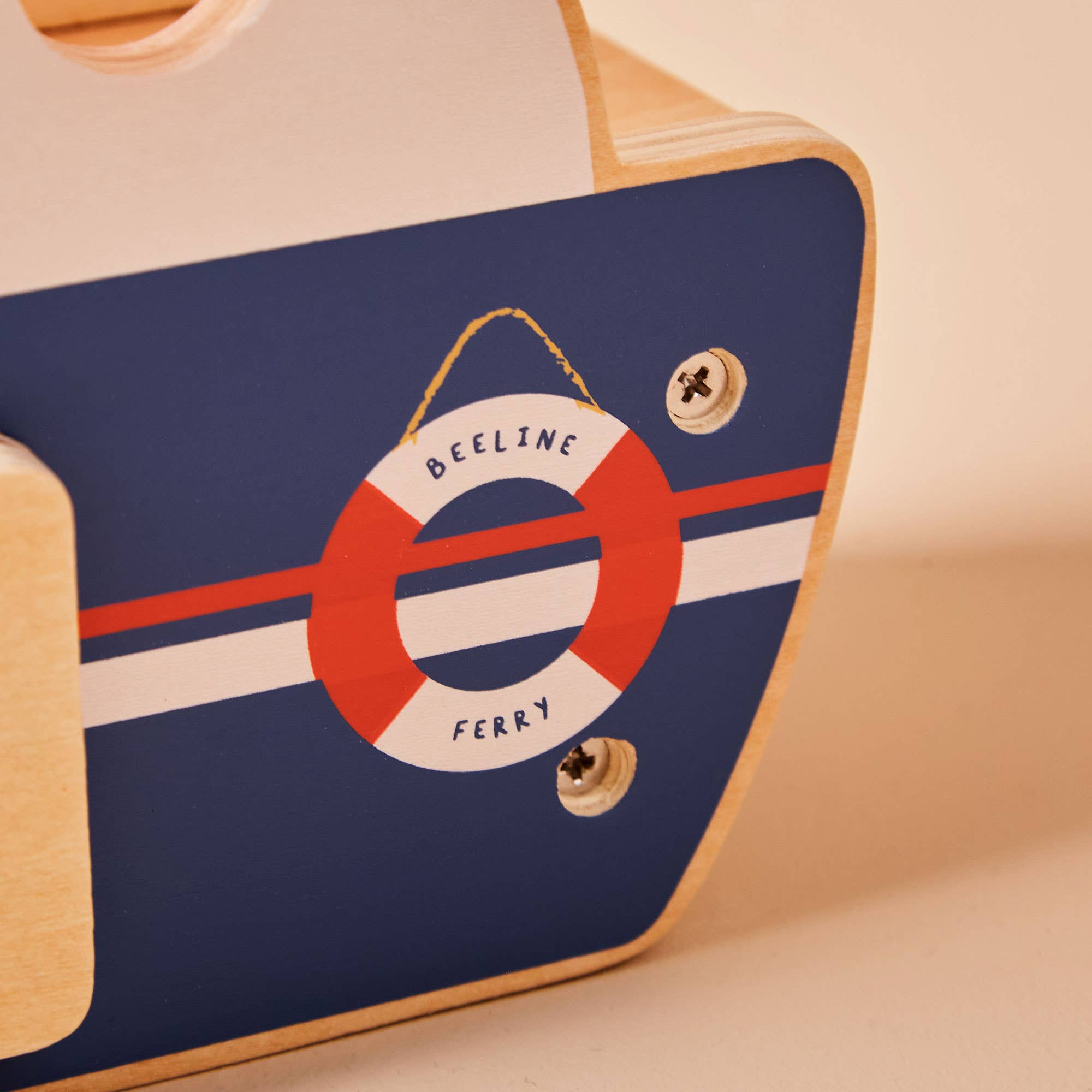Close-up of a product with a life buoy design and 'Beeline Ferry' text on a blue background.