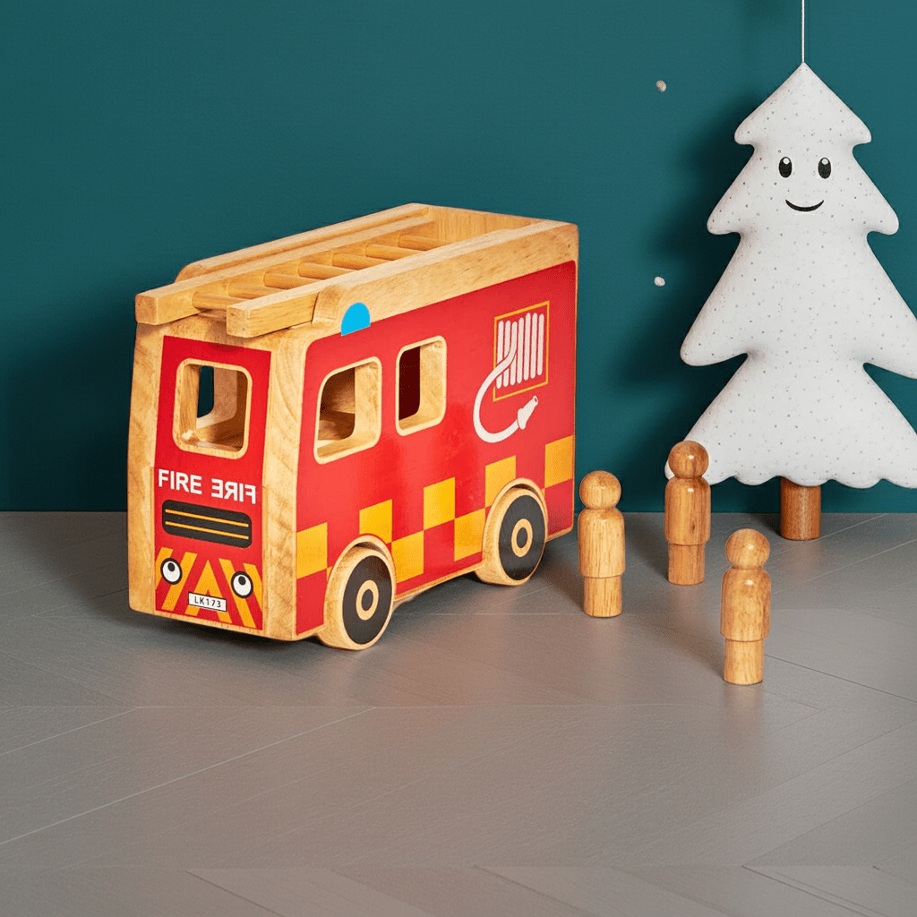 Wooden toy fire truck with wooden figures and a white tree-like figure on a gray floor against a teal wall.