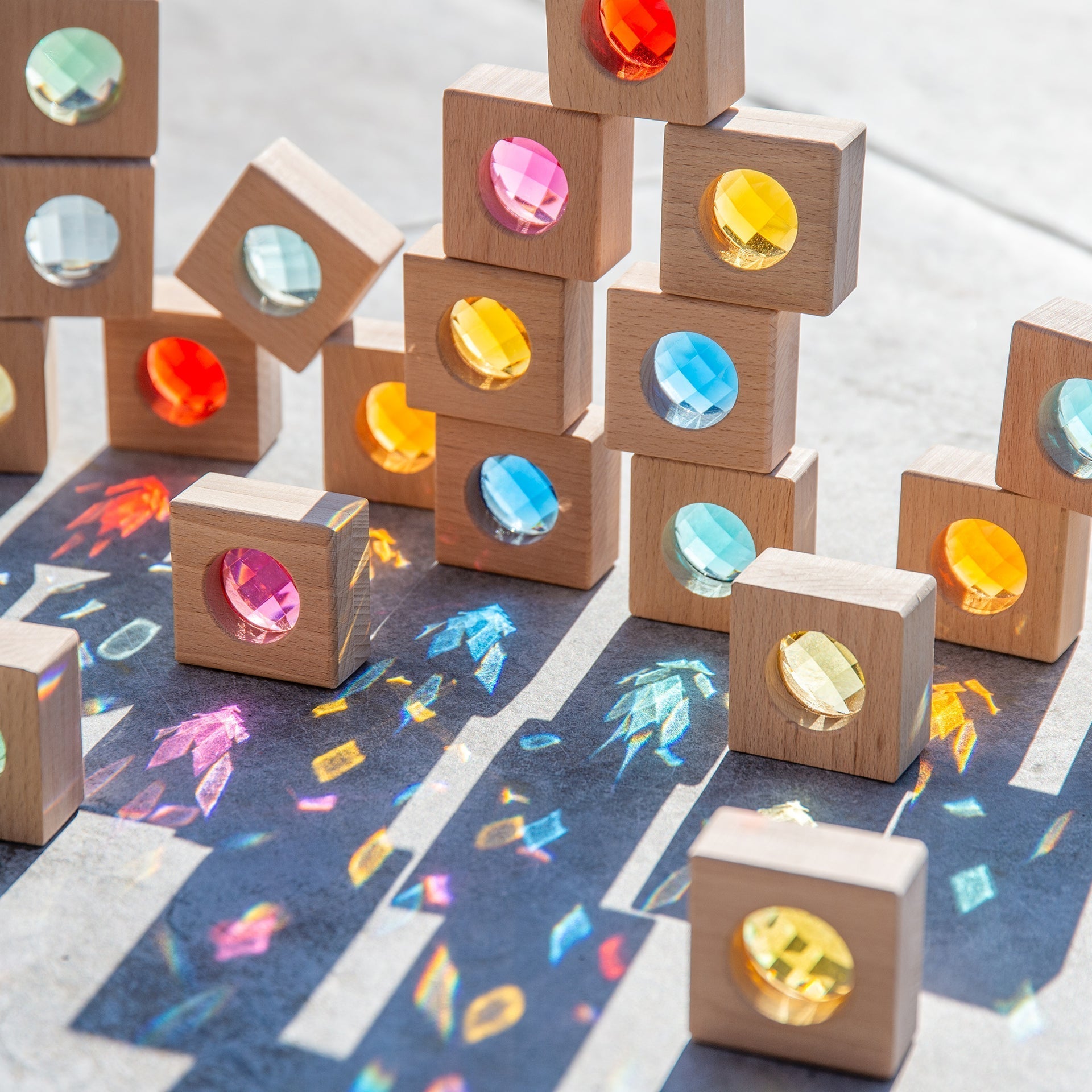 Wooden blocks with colorful gemstones on a patterned surface