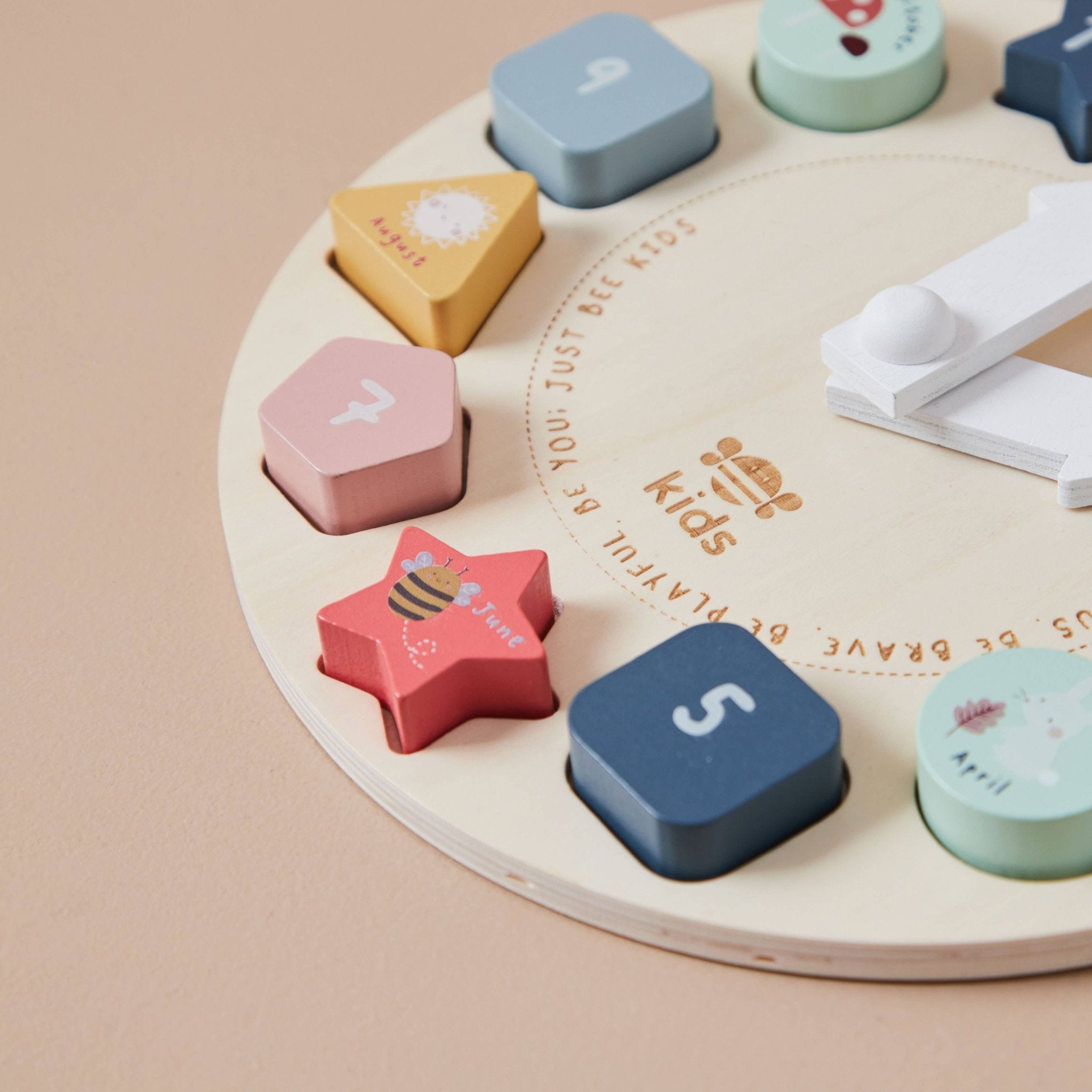 Colorful wooden shape sorter toy on a beige background