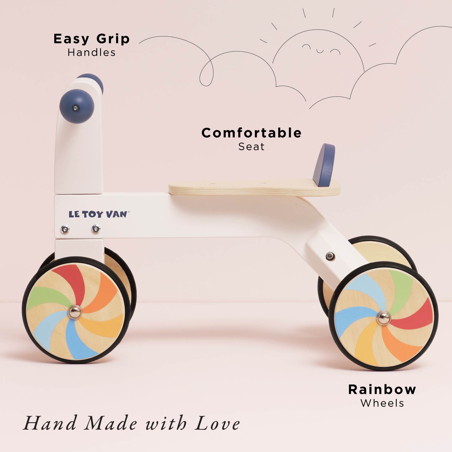 Children's push bike with colorful wheels on a light pink background, featuring text highlighting features like 'Easy Grip Handles' and 'Comfortable Seat'.