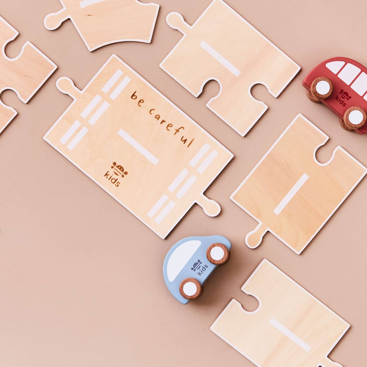 Wooden puzzle pieces with 'be careful' message on a beige background