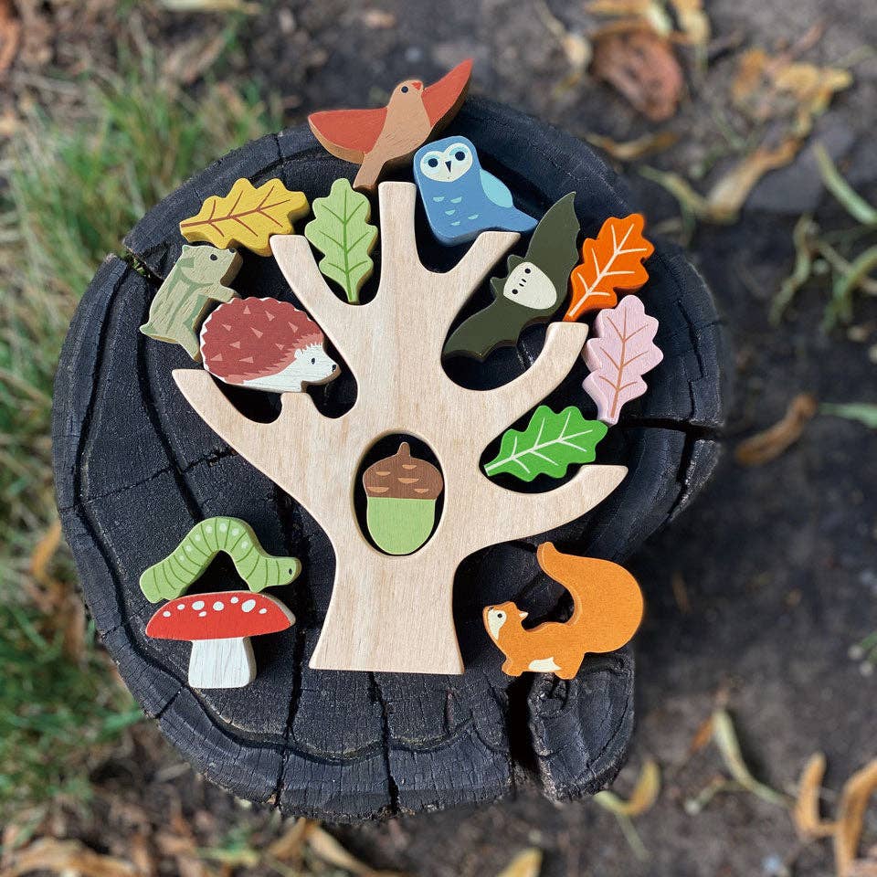 Wooden tree puzzle with animals and leaves on a natural background