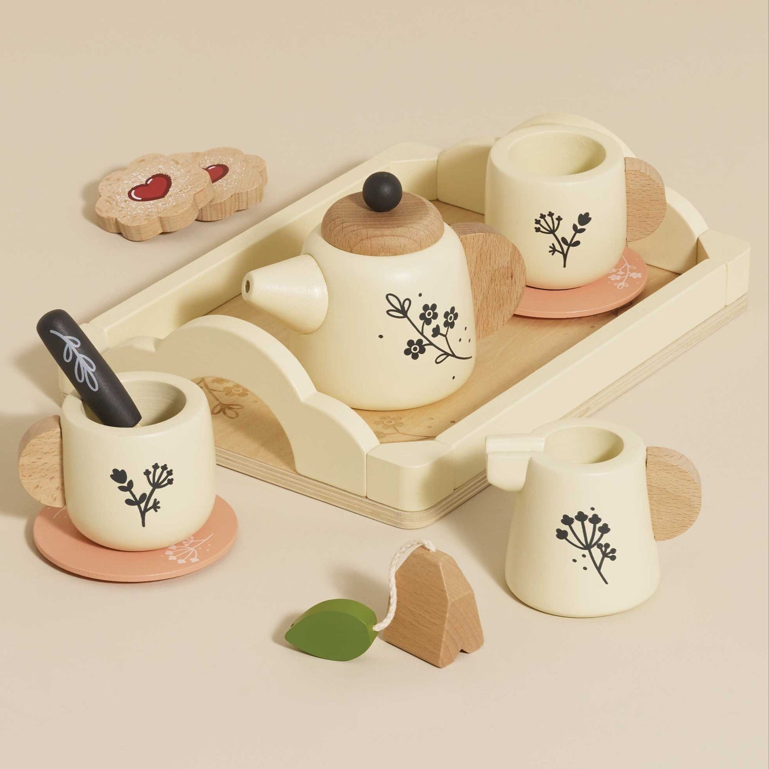 Wooden toy tea set with cups, teapot, and tray on a beige background