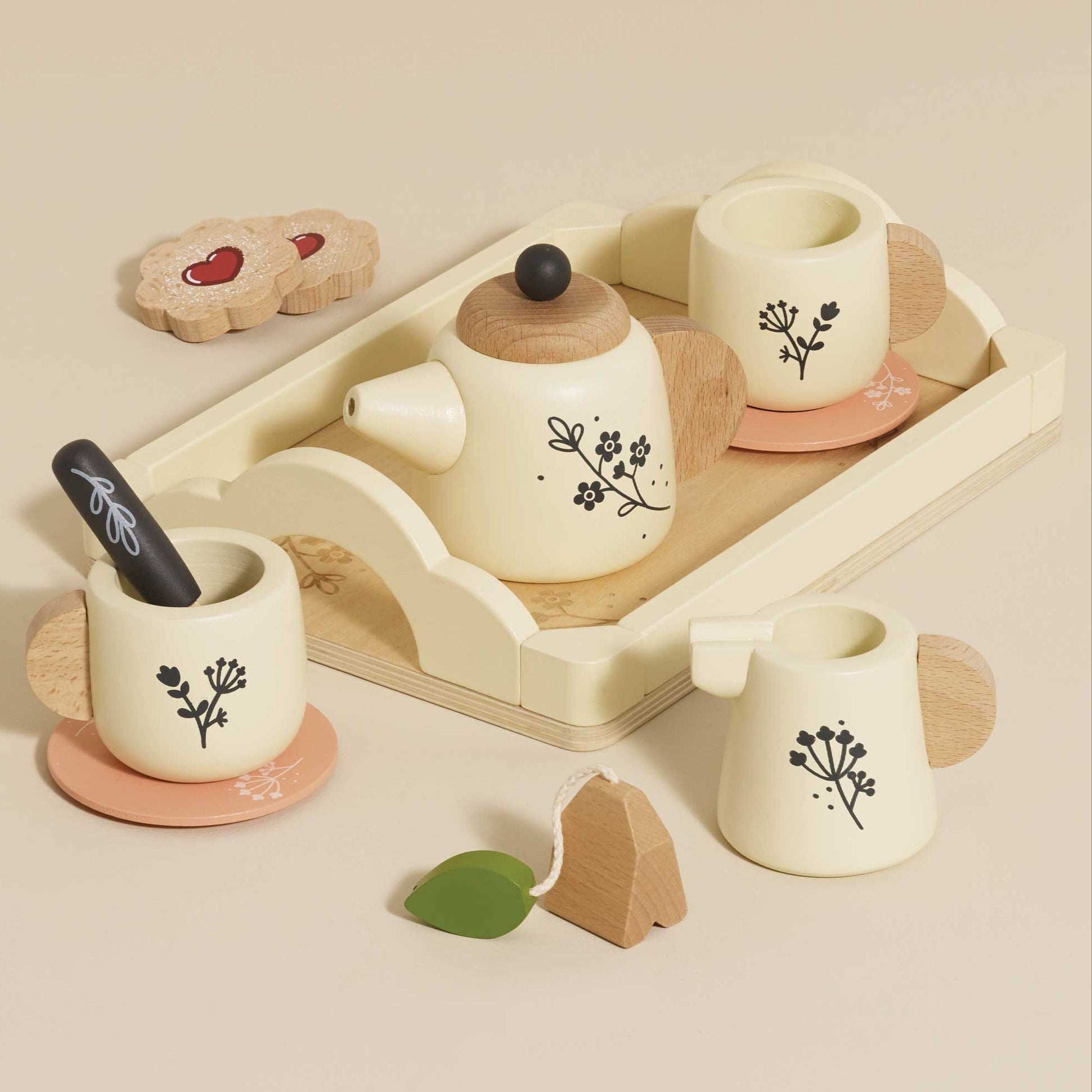 Wooden toy tea set with cups, teapot, and tray on a beige background