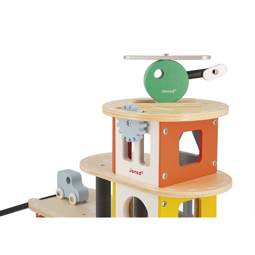 Wooden toy with gears and a car, featuring the Janod brand, on a white background.