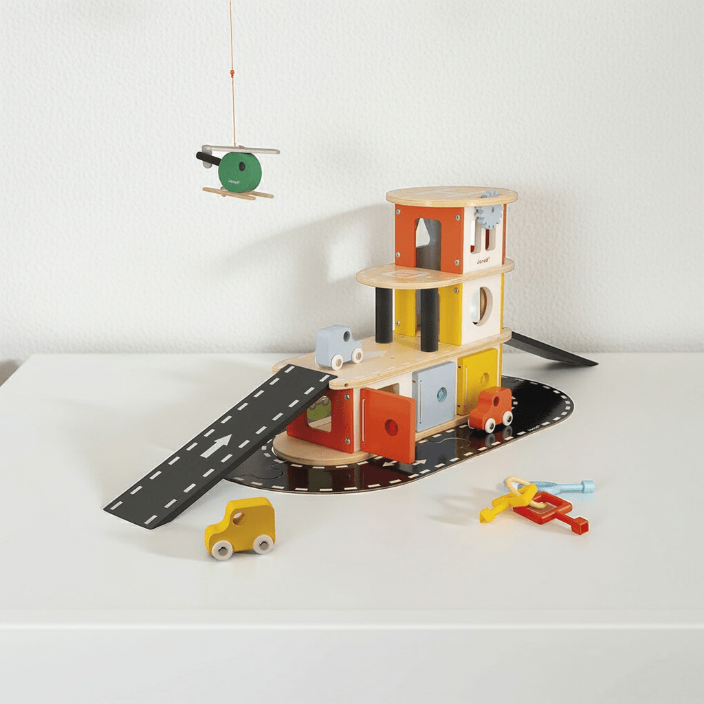 Colorful wooden toy airport with runways and small planes on a white surface.