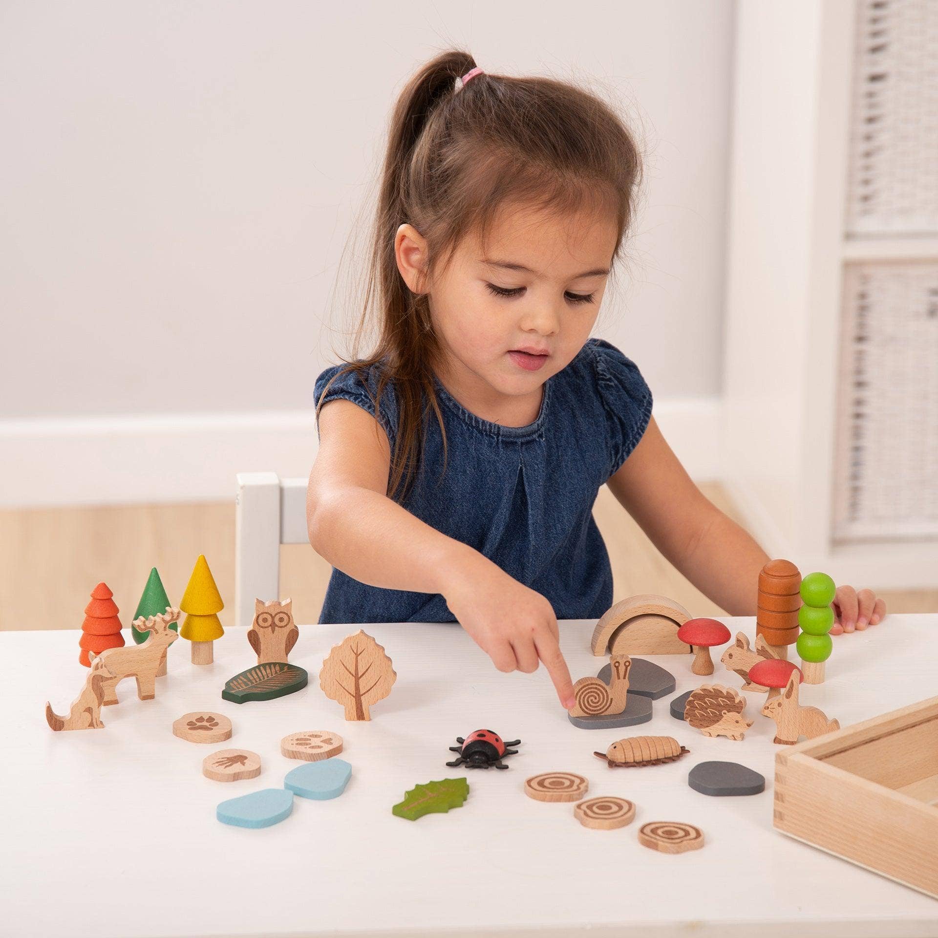 Child playing with wooden toys on a table