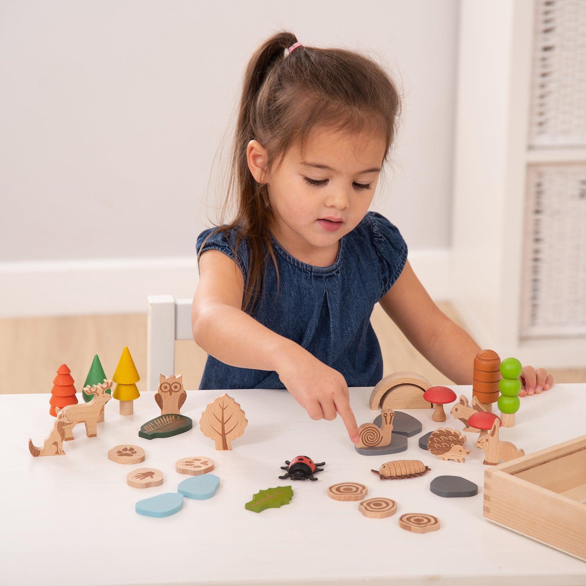 Child playing with wooden toys on a table