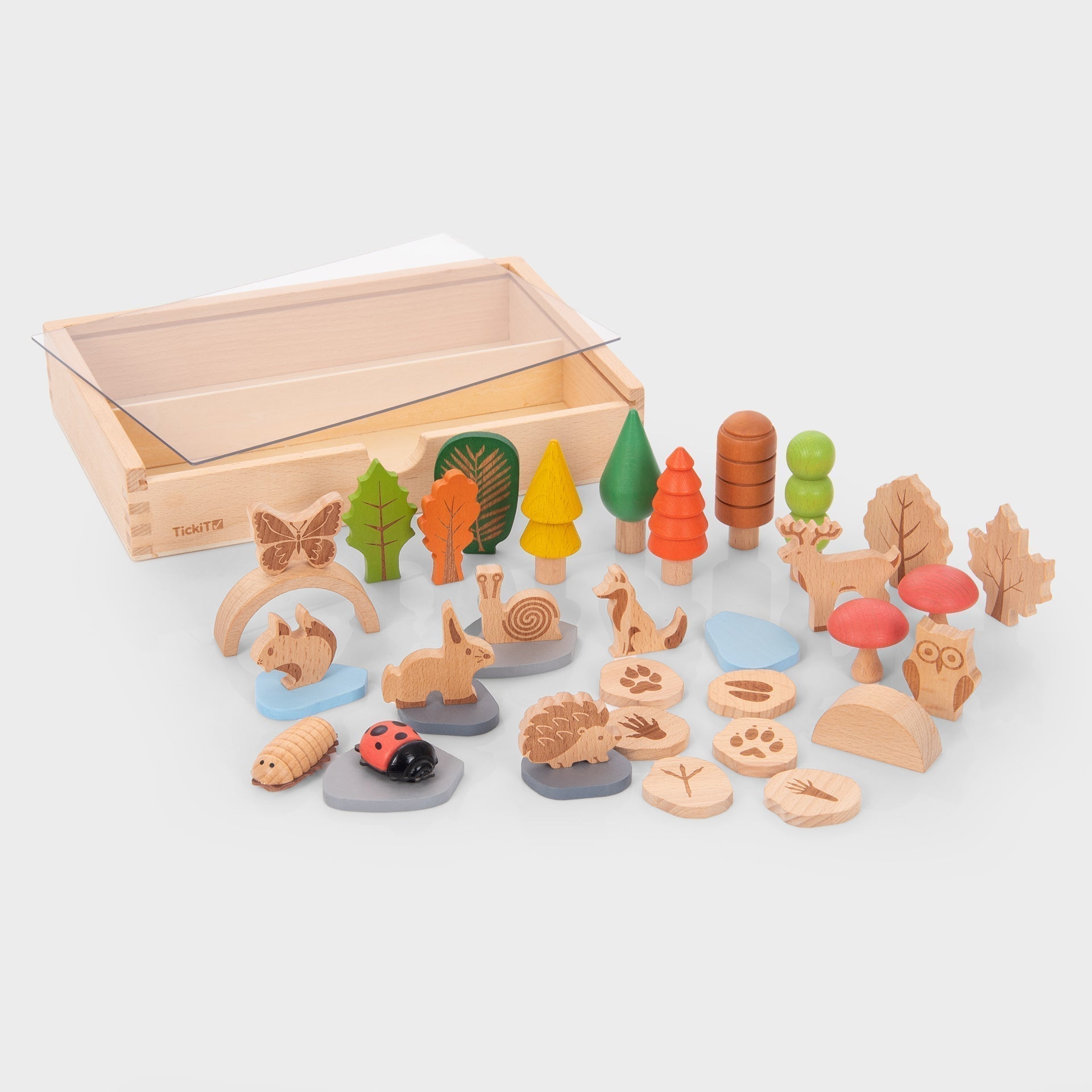 Set of wooden forest-themed toys with a transparent box on a white background