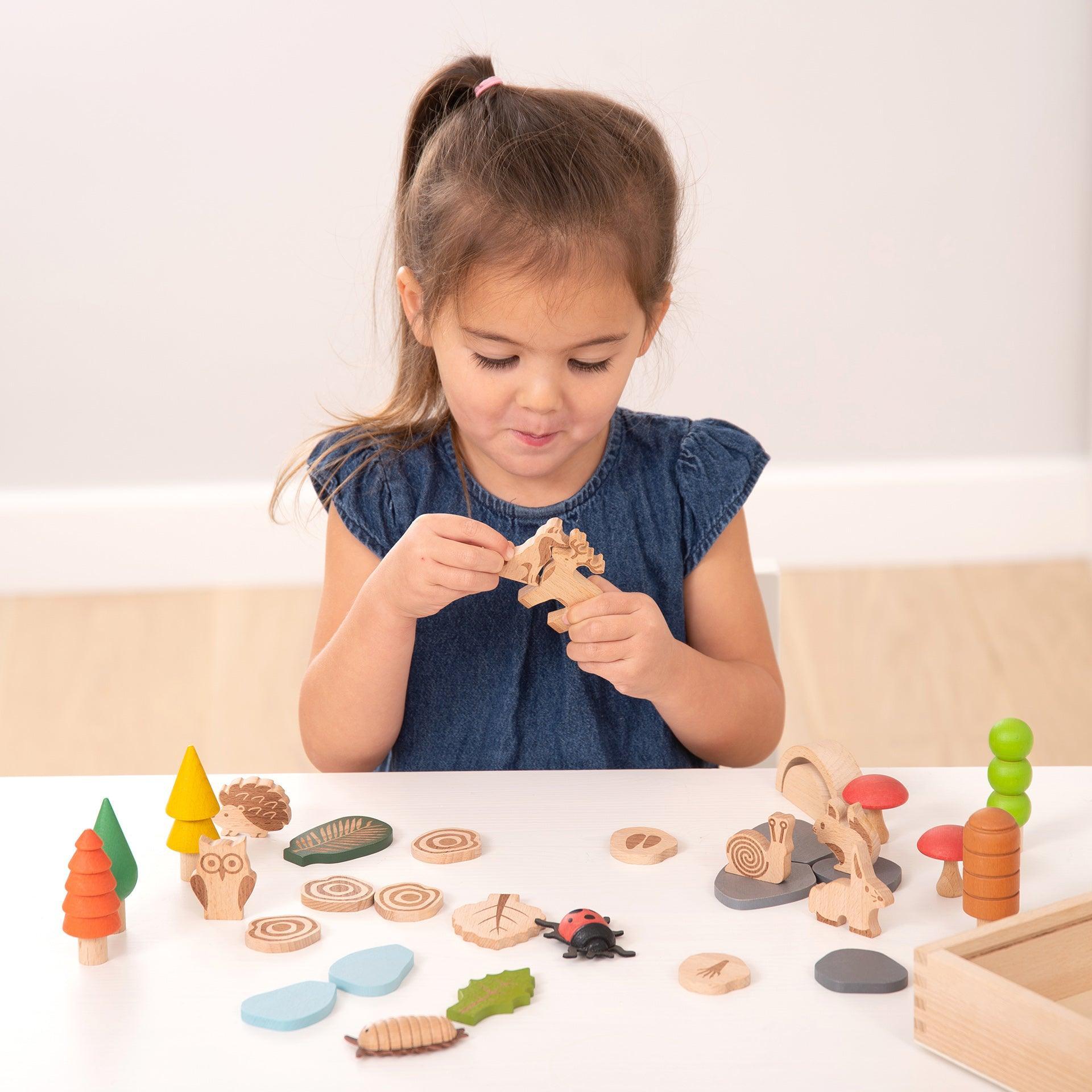 Child playing with wooden toys on a table
