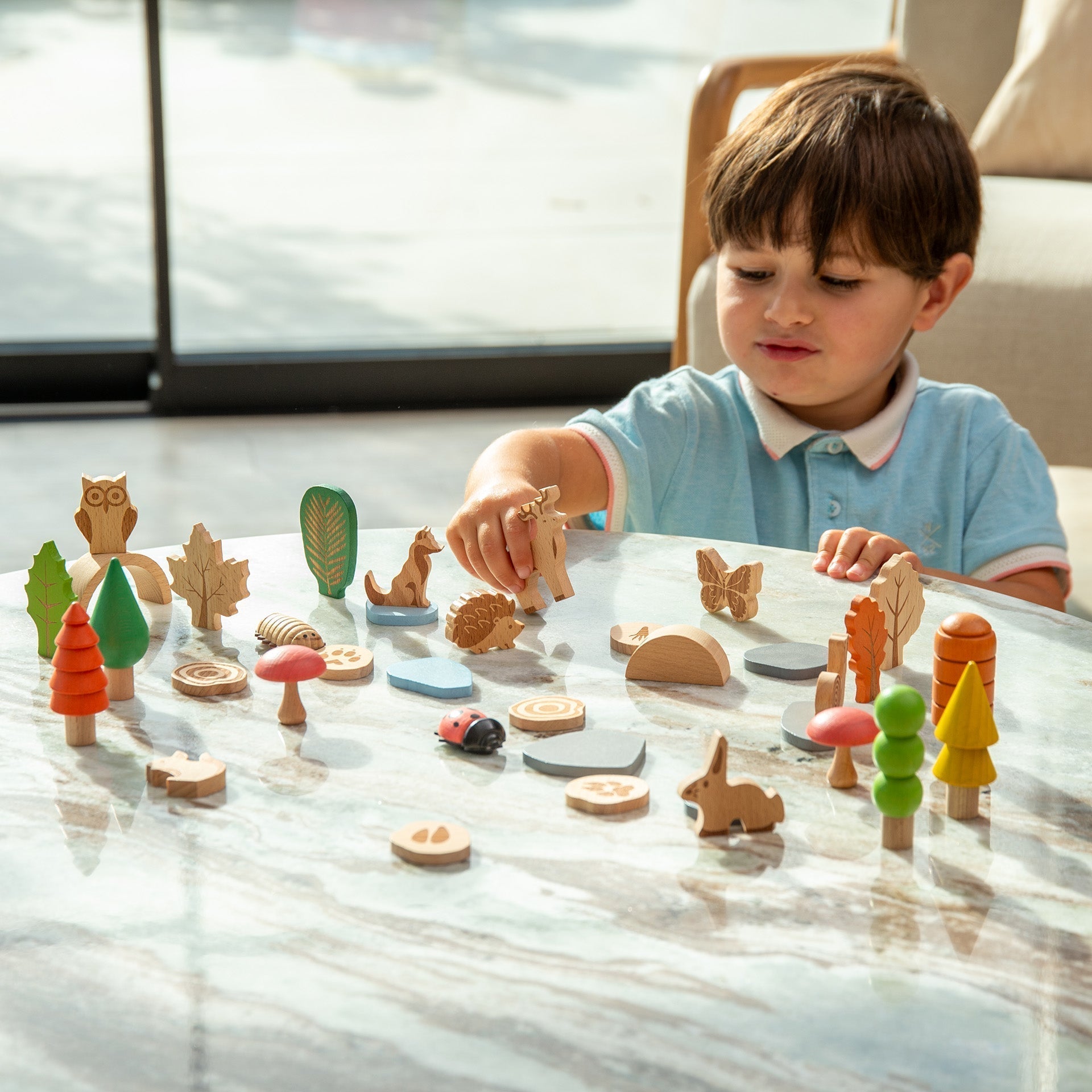 Child playing with wooden toys on a table indoors