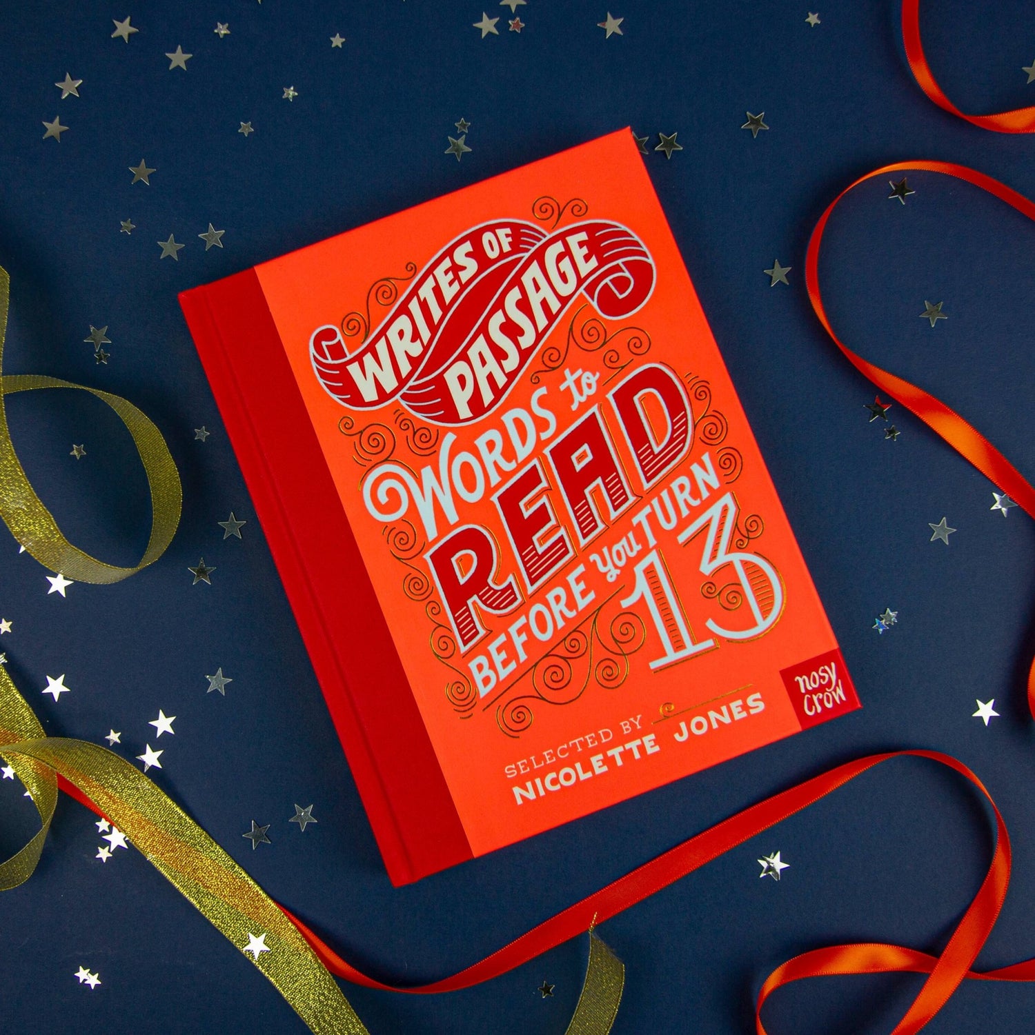 Red book titled 'Writes of Passage: Words to Read Before You Turn 13' on a dark blue background with ribbons.