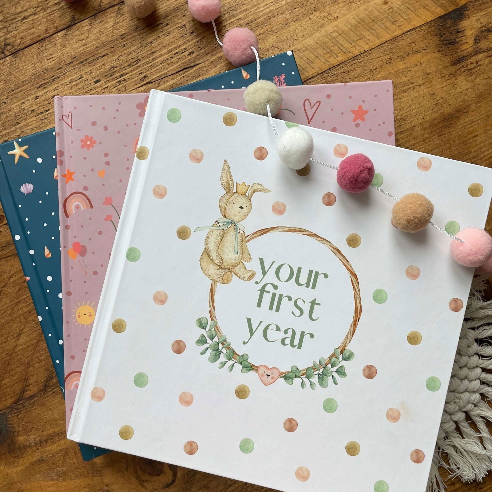 Book titled 'your first year' with a bunny illustration on a wooden surface.